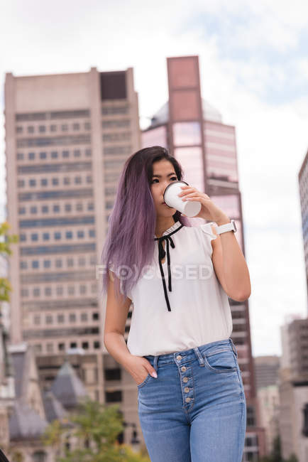 Beautiful woman having coffee on street — Stock Photo