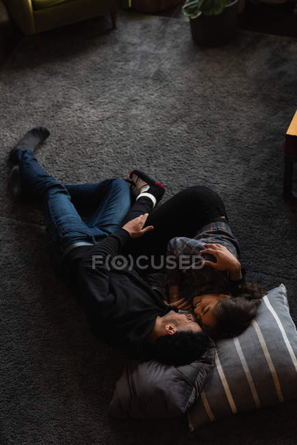 Счастливая пара отдыхает на полу дома — стоковое фото