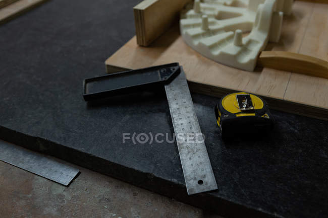 Close-up of try square and measure tape in foundry workshop — Stock Photo