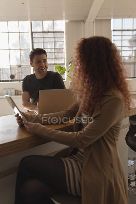 Young executives talking with each other in office — Stock Photo