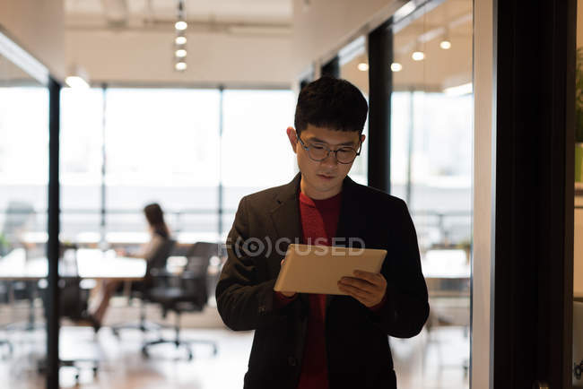 Male executive using digital tablet in office — Stock Photo