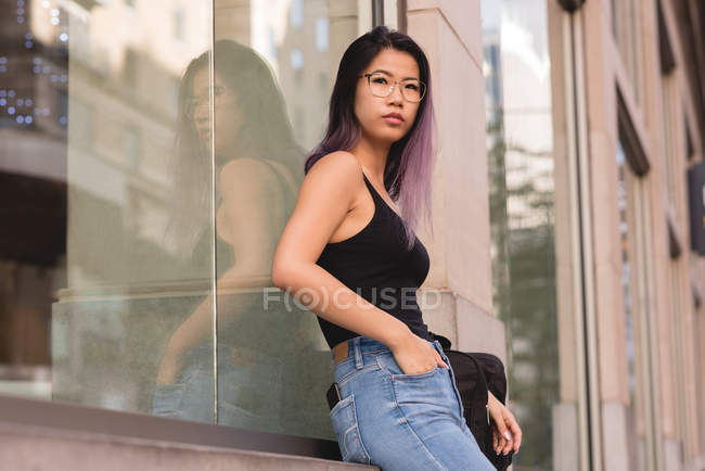 Thoughtful woman standing in city — Stock Photo