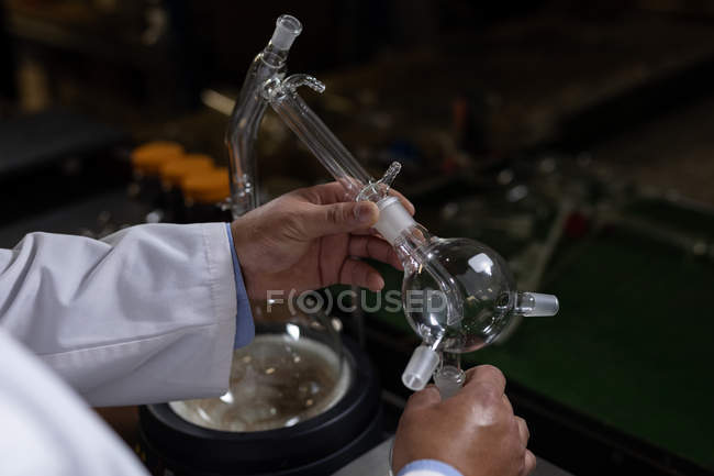 Close-up of worker examining glass product in glass factory — Stock Photo