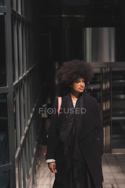 Thoughtful woman walking in city — Stock Photo