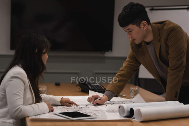 Executives discussing over blueprint in office — Stock Photo