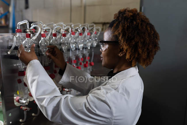Side view of female worker working in glass factory — Stock Photo