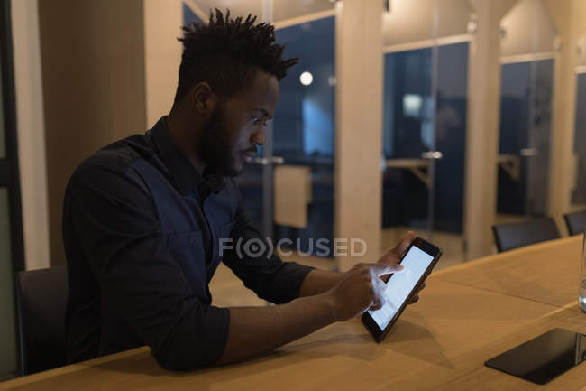 Uomo d'affari che utilizza tablet digitale alla scrivania in ufficio — Foto stock