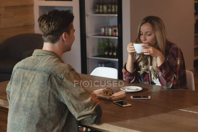 Jovem casal tomando café no café — Fotografia de Stock