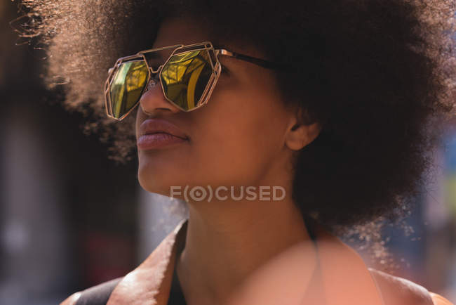 Thoughtful woman in city on a sunny day — Stock Photo