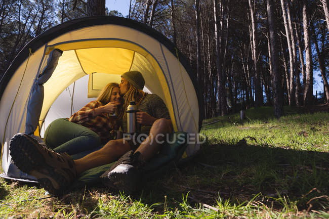 Young couple having coffee in tent — Stock Photo
