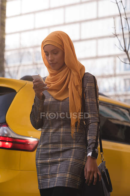 Hijab donna che utilizza il telefono cellulare in città — Foto stock