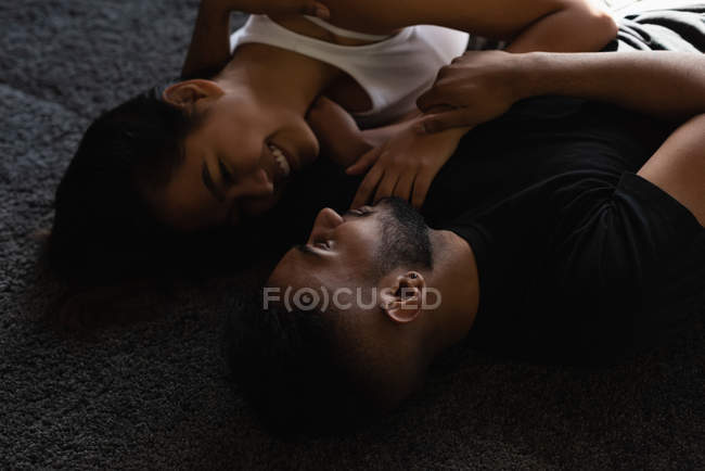 Happy couple looking at each other at home — Stock Photo