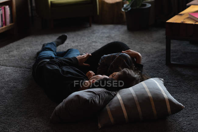 Casal jovem relaxante no chão em casa — Fotografia de Stock
