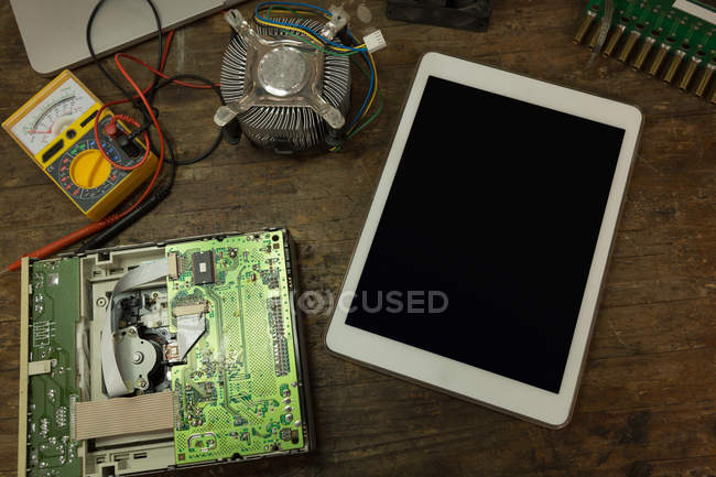 Close-up of digital tablet and circuit board on table — Stock Photo