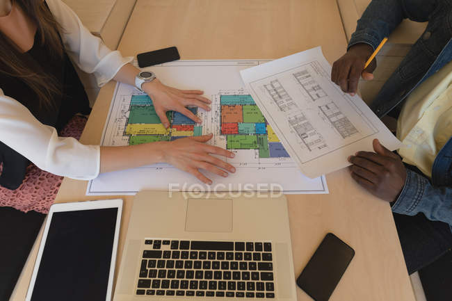 Mid section of business colleagues working together in office — Stock Photo