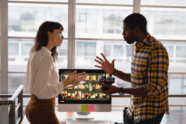Front view of diverse business people discussing with each other in office — Stock Photo
