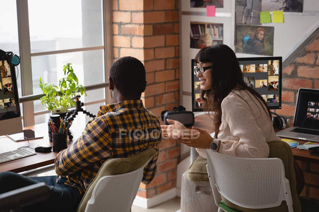 Rear view of diverse business people talking with each other in office — Stock Photo
