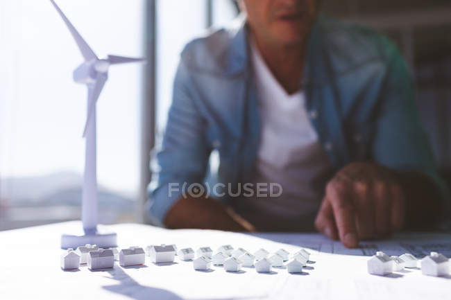 Mid section Caucasian male architecture working on architectural model at desk in modern office — Stock Photo
