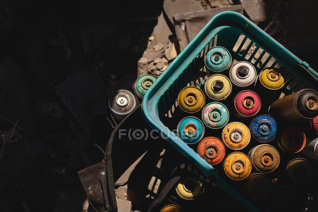 High angle view of colorful aerosol cans kept in basket — Stock Photo