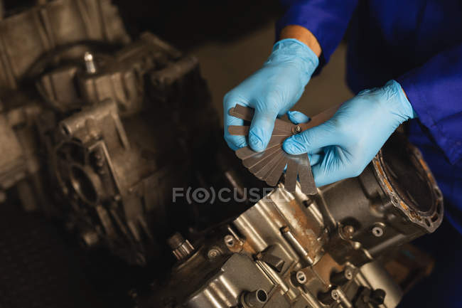 High angle view of bike mechanic repairing bike engine in garage — Stock Photo
