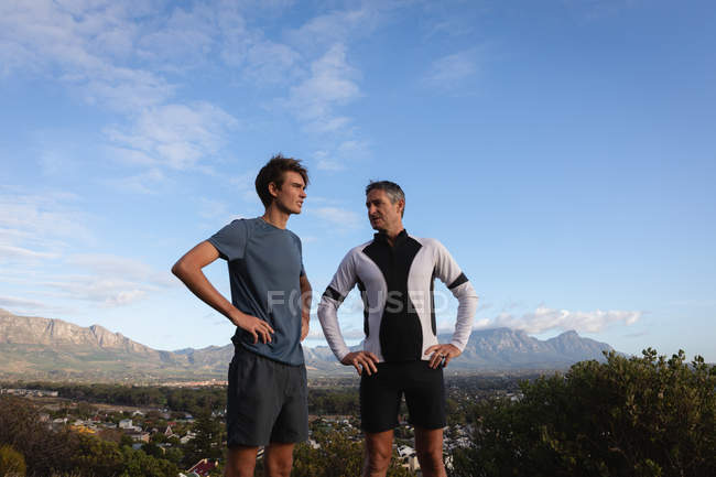 Low angle view of Caucasian father and son interact with each other — Stock Photo