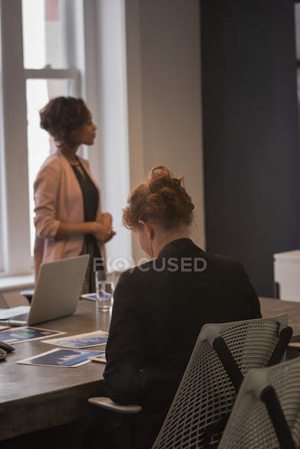 Rear view of businesswomen at meeting in conference room — Stock Photo