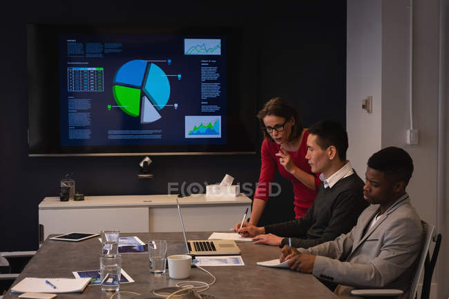 Side view of diverse business people having meeting in conference room at office — Stock Photo