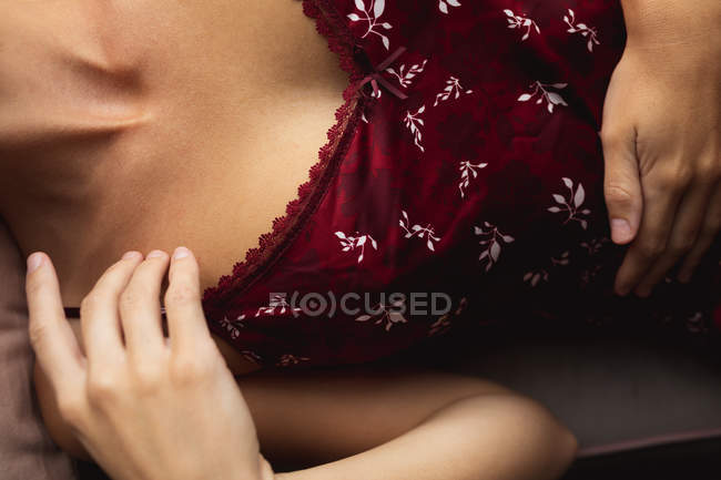 Closed-up of woman lying on window seat at home — Stock Photo