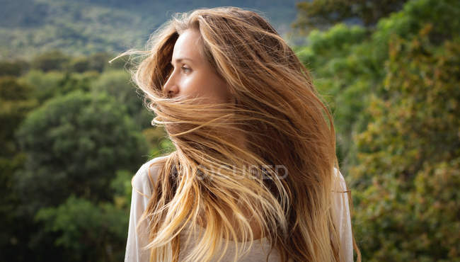 Front view of beautiful Caucasian woman shaking her head in the balcony — Stock Photo