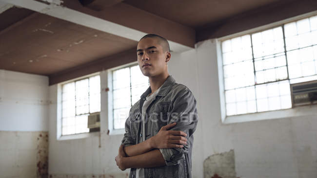 Low angle view of a young Hispanic-American man with piercing on both ears and nose — Stock Photo
