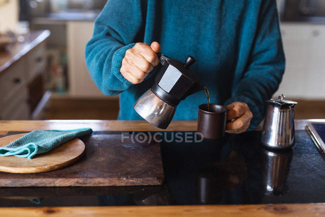 Front view close up of woman making coffee at home — Stock Photo