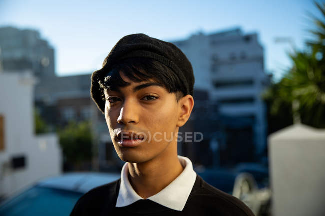 Portrait of a fashionable young mixed race transgender adult in the street, wearing a beret — Stock Photo