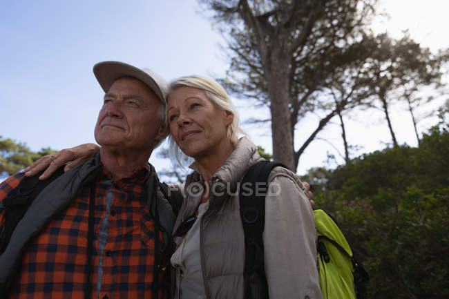 Front view close up of a mature Caucasian man and woman embracing during a walk in a rural setting — Stock Photo