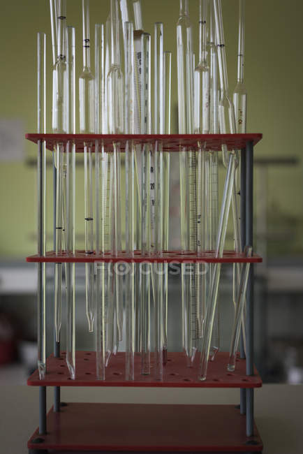 Close-up of pipettes in stand on desk — Stock Photo