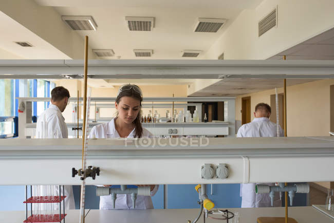 Young college students practicing experiment in lab — Stock Photo