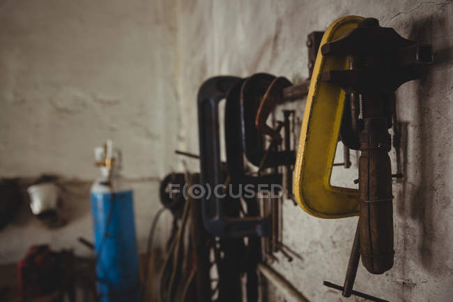 Tools hanging on wall in workshop — Stock Photo
