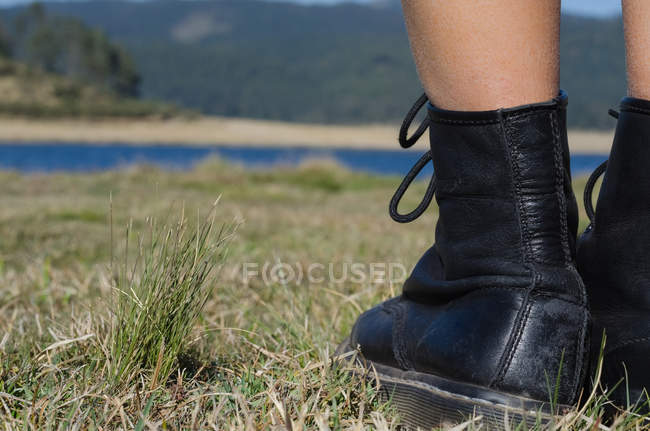 Close up of female hiker standing on field — Stock Photo