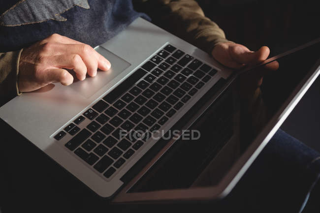 Mid-section of craftsman using laptop in workshop — Stock Photo