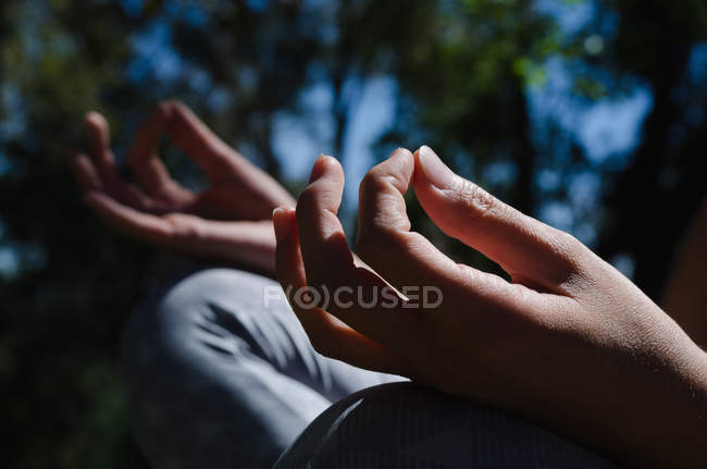 Close up of woman meditating during sunny day — Stock Photo