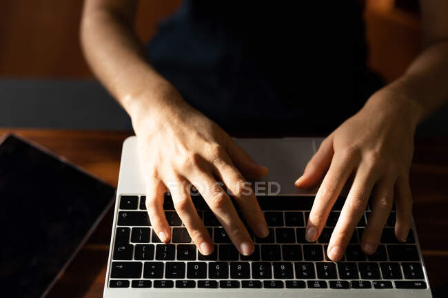 Hands of woman spending time at home, working from home, using her laptop. Lifestyle at home isolating in quarantine lockdown during coronavirus covid 19 pandemic. — Stock Photo