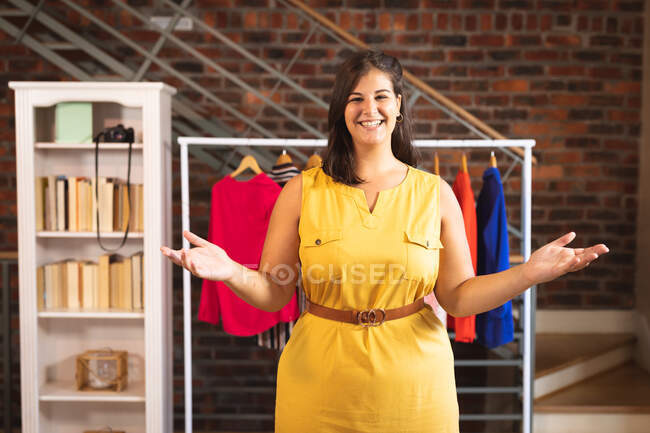Caucasian female vlogger at home in her dressing room, demonstrating trendy clothes for her online blog. Social distancing and self isolation in quarantine lockdown. — Stock Photo