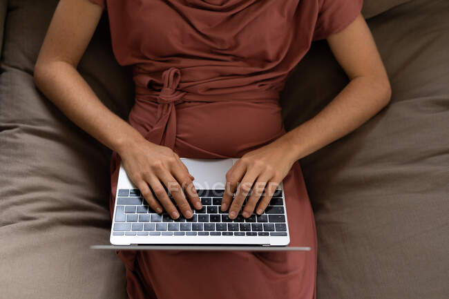 Hands of woman spending time at home, using her laptop. Lifestyle at home isolating, social distancing in quarantine lockdown during coronavirus covid 19 pandemic. — Stock Photo