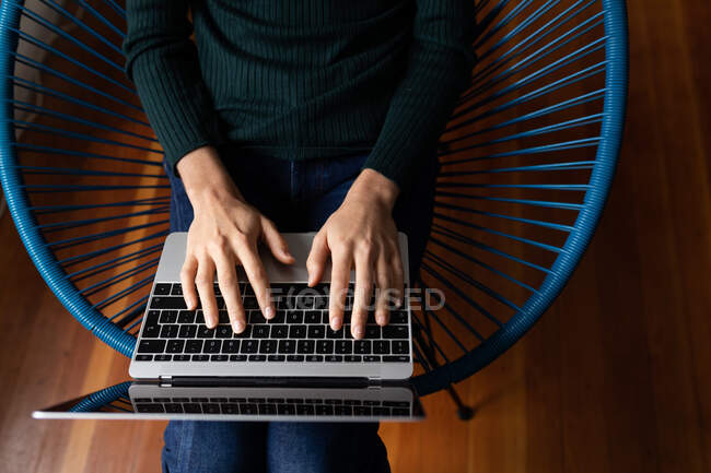 Mid section of woman spending time at home, working, using her laptop. Lifestyle at home isolating, social distancing in quarantine lockdown during coronavirus covid 19 pandemic. — Stock Photo