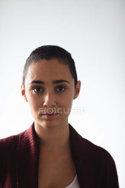Portrait close up of a mixed race woman with short hair wearing a cardigan, looking straight to camera at home — Stock Photo