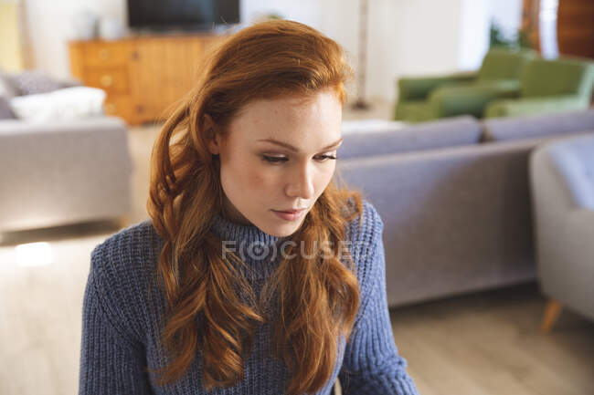 Caucasian woman spending time at home, in the kitchen, working from home, using her laptop. Social distancing during Covid 19 Coronavirus quarantine lockdown. — Stock Photo