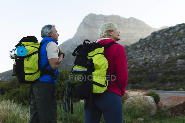 Senior couple spending time in nature together, walking in the mountains. healthy lifestyle retirement activity. — Stock Photo