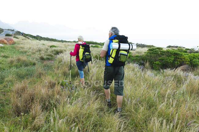 Casal sênior passando tempo na natureza juntos, andando nas montanhas. atividade de aposentadoria saudável. — Fotografia de Stock