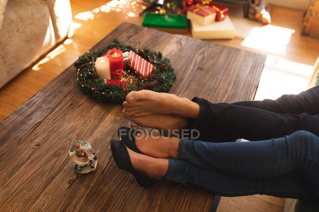Niedrige Abschnitt des Paares entspannen im Wohnzimmer in der Weihnachtszeit. Selbstisolation während Coronavirus covid 19 Quarantäne Lockdown. — Stockfoto