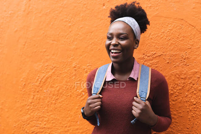 Portrait of african american woman smiling on street out and about in the city during covid 19 coronavirus pandemic. — Stock Photo