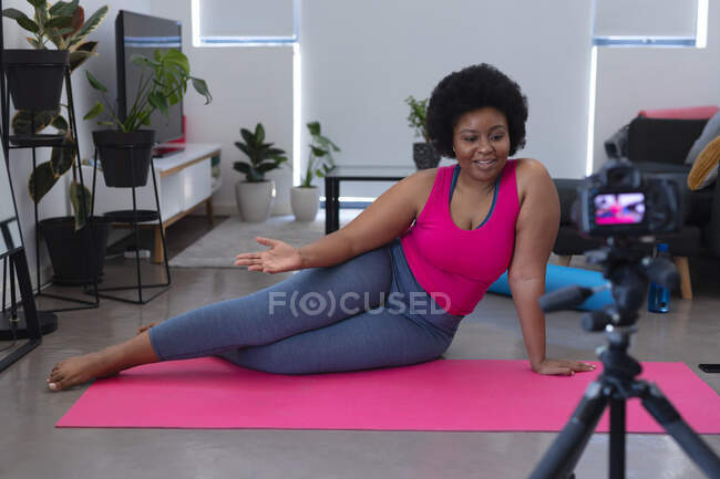 African american female vlogger recording a video. about meditation. self isolation technology communication at home during coronavirus covid 19 pandemic. — Stock Photo